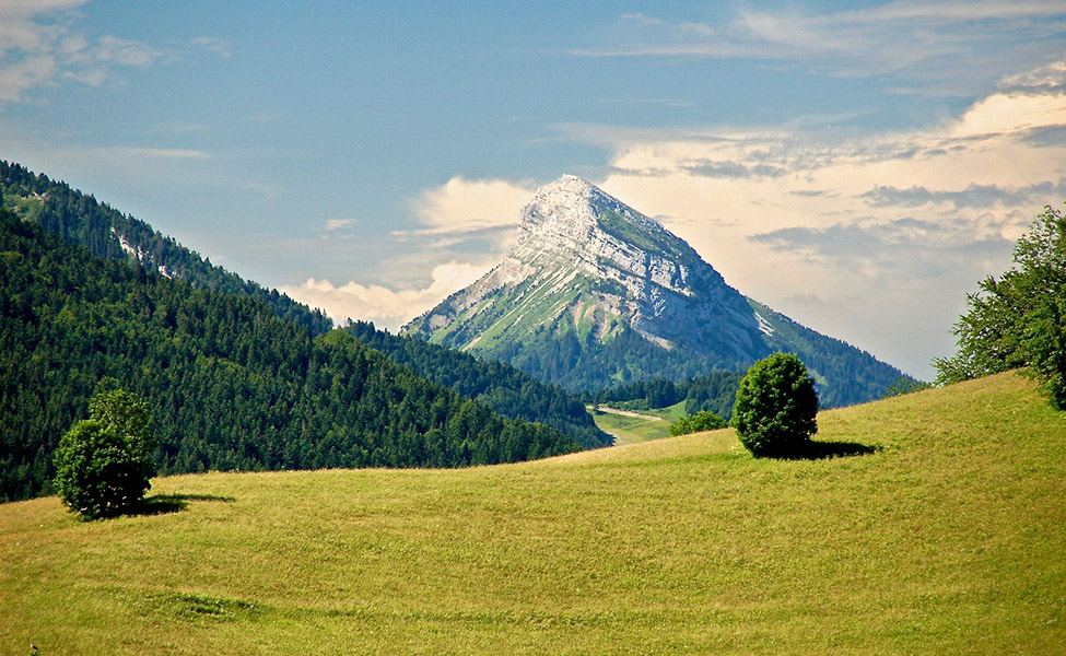 Mountain with green land around it