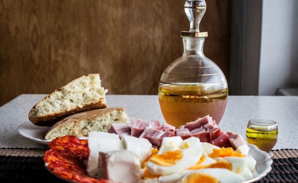 Platter of food and a bottle of drink on the table 