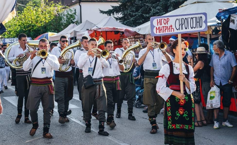 people in traditional serbian clothes on the trumpet festival