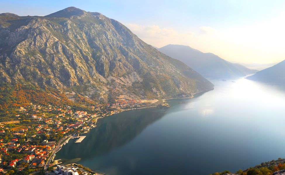 Aerial view of a mountain and a coastal town in Montenegro 