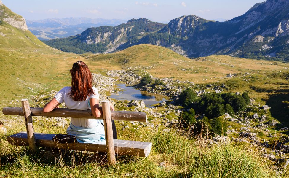 Woman sitting on a bench in Durmitor National park 