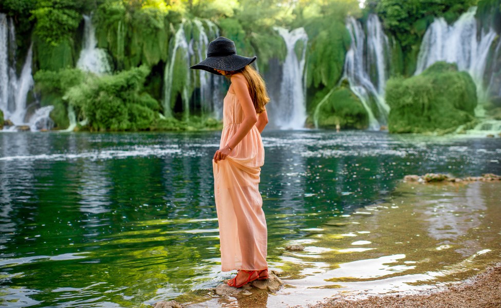 Woman next to a waterfall in Bosnia